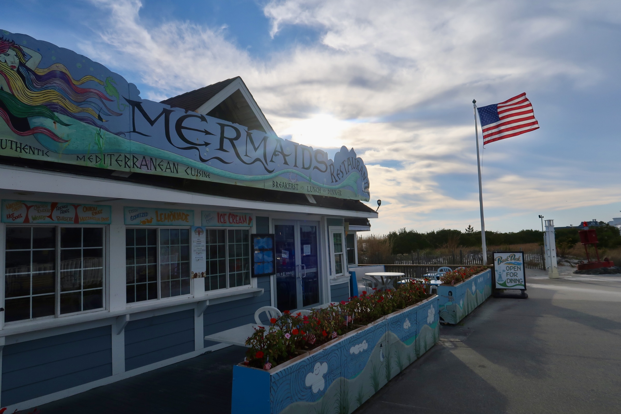 American flag in front of Mermaids on the promenade